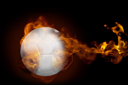 Composite image of fire surrounding football against black