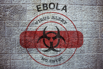 Ebola virus alert against grey brick wall