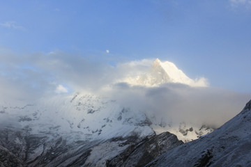 Annapurna Mountain Range with snow at sunrise in Annapurna Mountain Range from the base camp in Nepal. Fog, unclear, risk, dangerous, doubt concepts