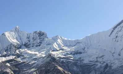 Fototapeta na wymiar Annapurna Mountain Range covered with snow from the base camp in Nepal. Summit, peaks, challenge concept