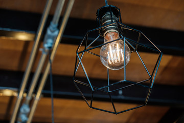 Fototapeta na wymiar Vintage Retro Light Bulb hanging Down from the Ceiling.