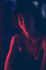 Portrait of a woman in a dark bar