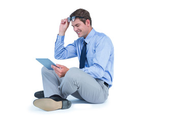 Businessman sitting and using tablet