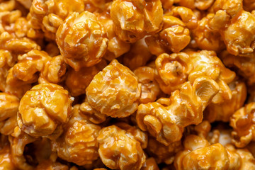 Yummy popcorn with caramel as background