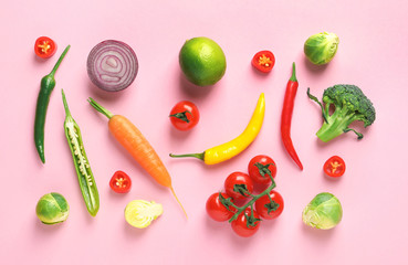 Flat lay composition with fresh vegetables and fruit on color background