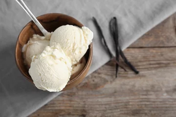  Wooden bowl with tasty vanilla ice cream on table © New Africa