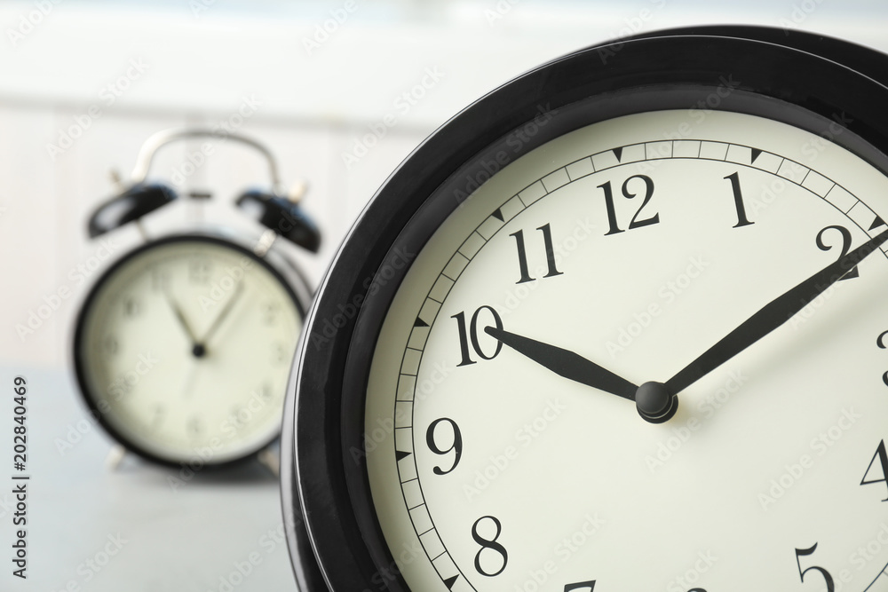 Poster black clocks on table. time change concept