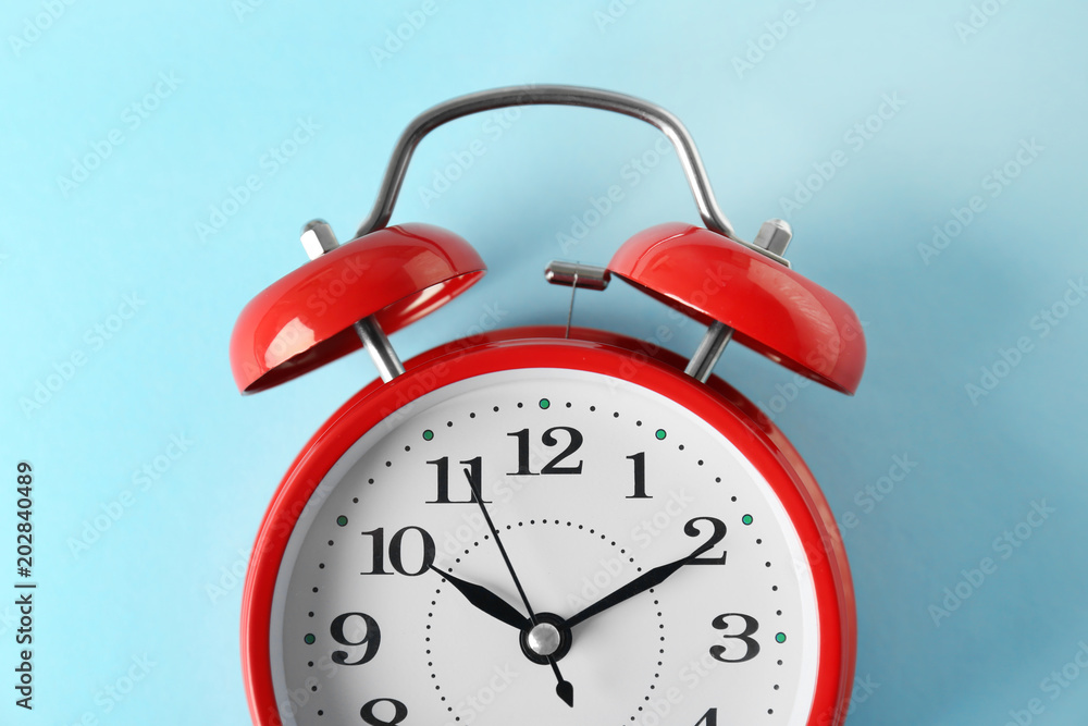 Poster Alarm clock on color background. Time change concept