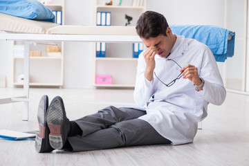 Doctor sitting on the floor in hospital