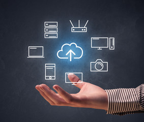 Cloud and computing related icons hovering over young hand 