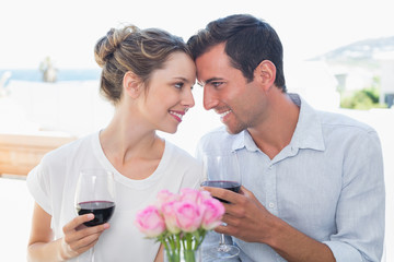 Couple with wine glasses looking at each other