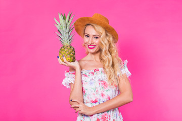 Portrait of happy woman and pineapple over pink background. Summer, diet and healthy lifestyle concept