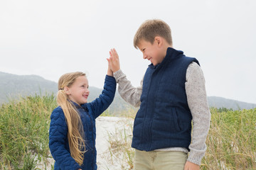 Happy brother and sister at beach