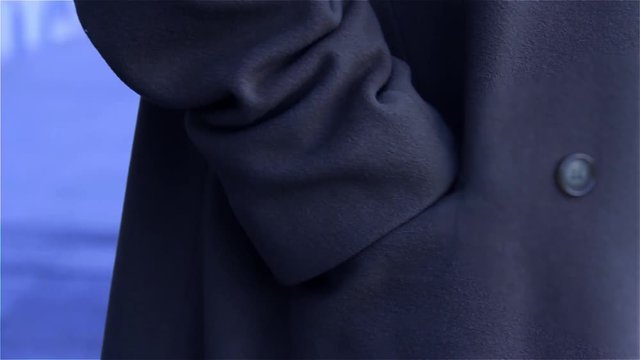 Man Taking Phone Out Of Pocket. Night Tone. Close-Up.