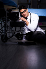 Fototapeta premium Doctor working night shift in hospital after long hours
