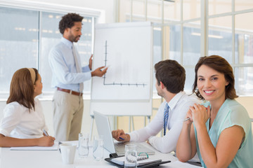 Fototapeta premium Businesswoman with colleagues in boardroom meeting