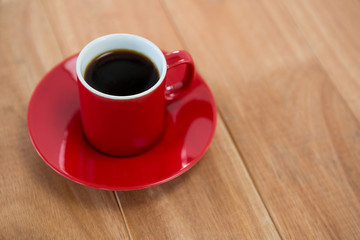 Black coffee served in red cup