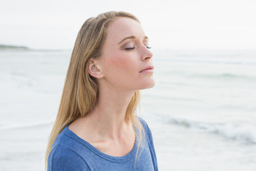 Woman with eyes closed at beach