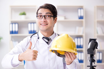 Safety doctor advising about wearing hard hat