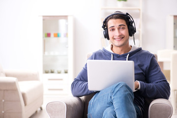 Fototapeta na wymiar Young handsome man listening to music with headphones