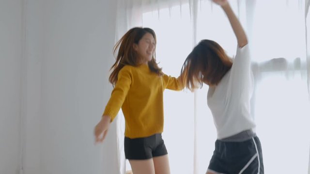 Young asian female lesbian couple dancing at bedroom. Lifestyle friendship concept.