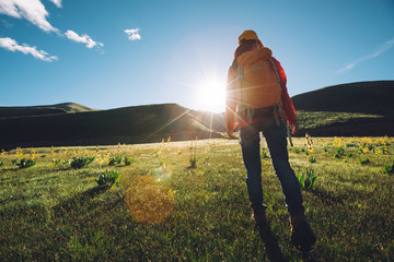 Backpacking woman hiker hiking in sunrise mountains