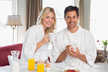 Happy young couple having breakfast