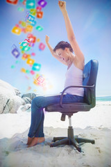 Cheering brunette using laptop on the beach sitting on swivel chair with colourful computer applications