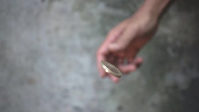 slowmotion shot tossing coin to flip on heads or tails