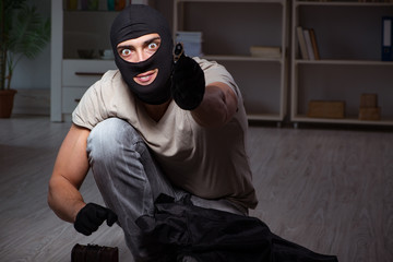 Burglar wearing balaclava mask at crime scene