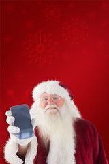 Santa Claus shows a smartphone against red background