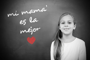 Schoolchild with blackboard against spanish mothers day message