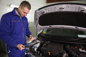Mechanic looking at a tablet computer