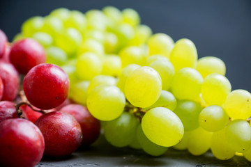 Sweet bunch of green grapes on th rustic background. Selective focus. Shallow depth of field.
