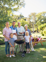 Happy family doing barbecue in the park