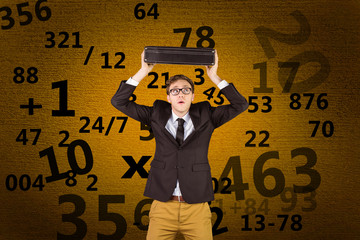 Young geeky businessman holding briefcase against orange background with vignette