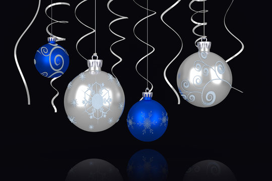 Composite image of Blue and silver christmas baubles against black