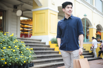 Young asian male shopping