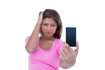 Naklejka premium Pretty brunette taking a selfie with smartphone