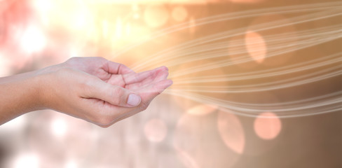 Hands presenting  against glowing background