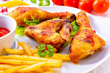 Grilled chicken wings,legs,chips and vegetables