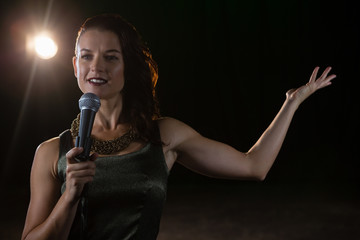 Female singer singing into a microphone