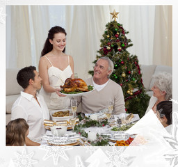 Woman showing turkey to her family for Christmas against christmas frame