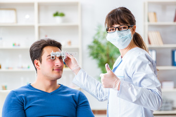 Ophthalmologist is checking up patient in eye doctor hospital