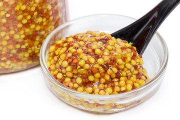 French mustard in small glass bowl at selective focus