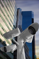 CCTV camera against low angle view of skyscrapers