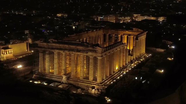 Aerial night video of iconic ancient Acropolis hill and the Parthenon at night, Athens historic center