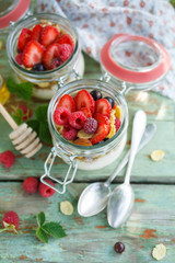 Delicious yogurt with raspberries in a serving jar, top view. Concept for healthy eating and nutrition.
