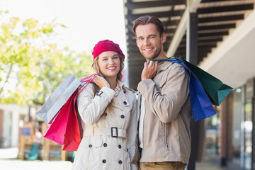 A happy couple with shopping bags 