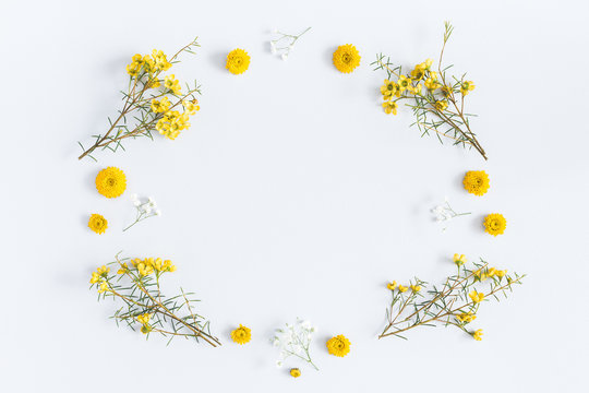 Flowers composition. Frame made of yellow flowers on gray background. Flat lay, top view, copy space